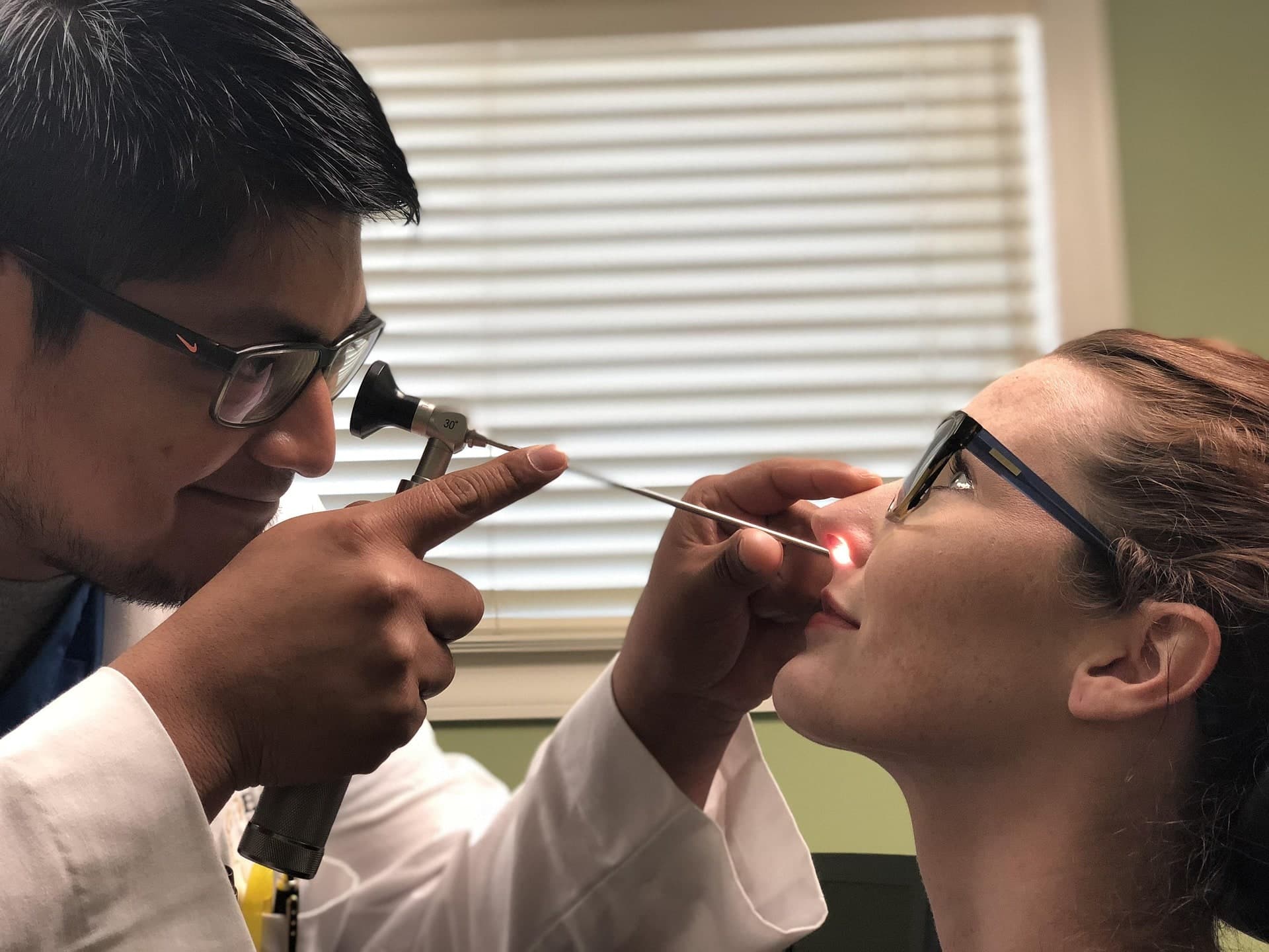 ENT clinician examining a patient's nasal passage