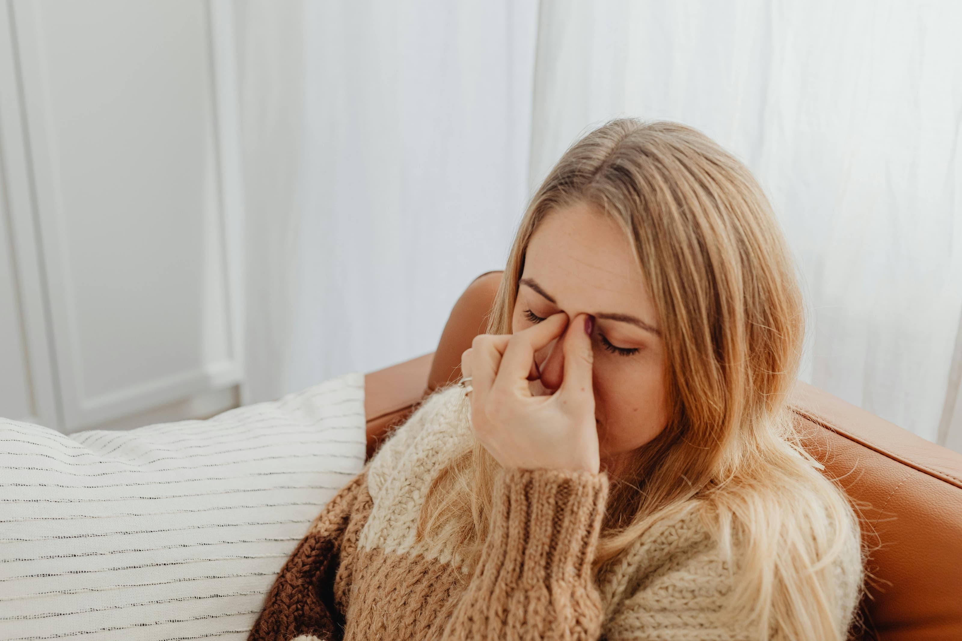 Patient with sinus discomfort discussing symptoms with an ENT specialist