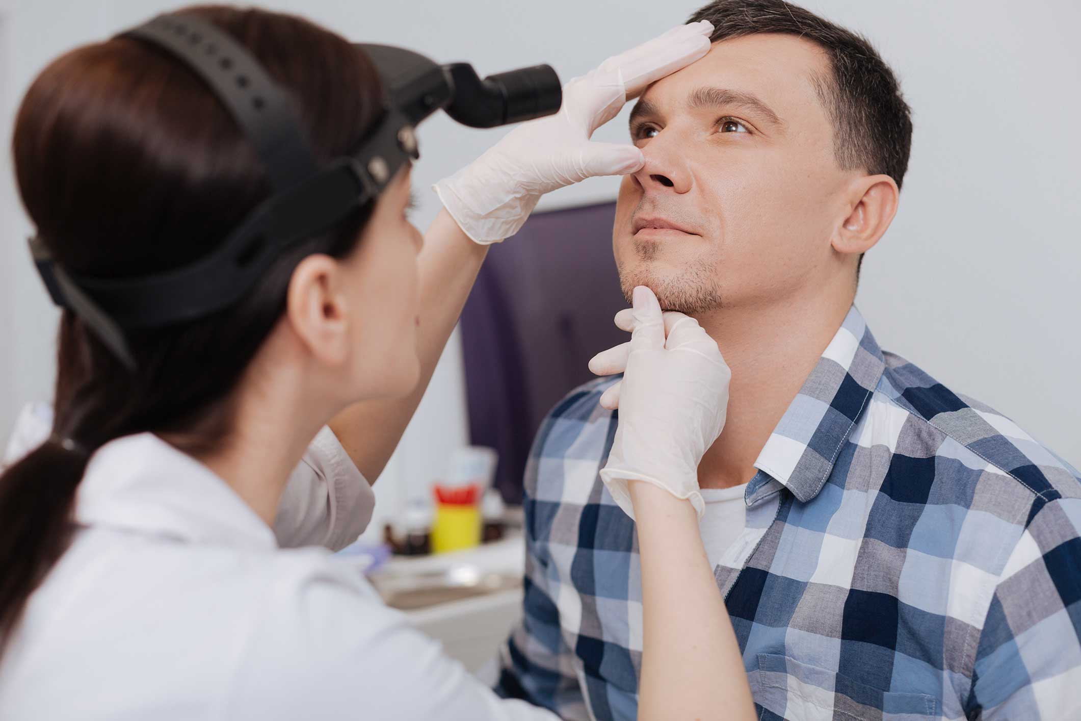 ENT specialist evaluating a patient for nasal obstruction
