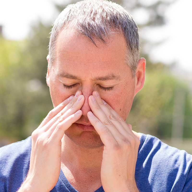 Man holding his nose